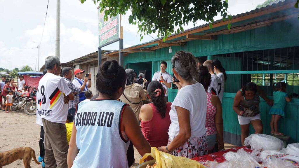 A group of people from the local community in the Amazon rainforest of Peru interacting with the Fund the Planet team.